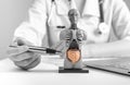 Doctor showing internal organs in 3d human model. Woman with stethoscope in lab coat sitting at desk with laptop Royalty Free Stock Photo