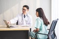 Doctor showing medical records on computer to his patient,he is pointing at the screen, Doctor explaining exam results in computer Royalty Free Stock Photo