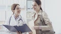 Doctor showing medical records to a patient