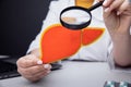 Doctor showing a model of liver by magnifier. Early diagnosis and treatment concept Royalty Free Stock Photo