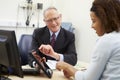 Doctor Showing Patient Test Results On Digital Tablet Royalty Free Stock Photo