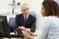 Doctor Showing Patient Test Results On Digital Tablet Royalty Free Stock Photo