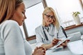 Doctor showing patient test results in office Royalty Free Stock Photo