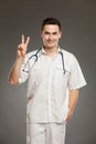Doctor showing peace sign or number two Royalty Free Stock Photo