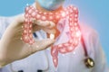 A doctor showing a pill to treat gut .