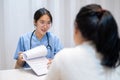 A doctor showing reports and giving advice to a patient during a medical check-up at the hospital Royalty Free Stock Photo