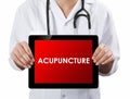 Doctor showing tablet with ACUPUNCTURE text. Royalty Free Stock Photo