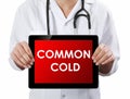 Doctor showing tablet with COMMON COLD text