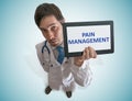 Doctor is showing tablet with pain management text written. Royalty Free Stock Photo