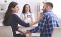 Doctor showing ultrasound picture to young happy couple