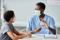 Doctor Showing Vaccine Flask to Child in Vaccination Clinic Royalty Free Stock Photo