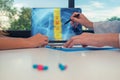 Doctor showing a x-ray of chest with pain in the spine on a laptop to a woman patient. Pills on the desk Royalty Free Stock Photo