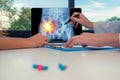 Doctor showing a x-ray of hips with left pain on a laptop to a woman patient. Pills on the desk Royalty Free Stock Photo