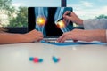 Doctor showing a x-ray of legs with pain in the knees on a laptop to a woman patient. Pills on the desk Royalty Free Stock Photo