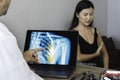 Doctor showing a x-ray of pain in the ribs of a woman patient Royalty Free Stock Photo