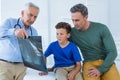 Doctor showing x-ray report to patient and his parent Royalty Free Stock Photo