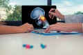 Doctor showing a x-ray of skull with pain in top of the neck on a laptop to a woman patient. Headache migraine or trauma concept