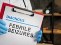 Doctor shows diagnosis febrile seizures on the medic form. Royalty Free Stock Photo