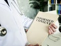 Doctor shows documents and informed consent form. Royalty Free Stock Photo