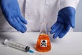 Doctor Shows Orange Poison Retort and Syringe - Labs Photo Royalty Free Stock Photo