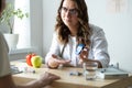 The doctor shows the glucometer to the patient. A female endocrinologist is seeing a patient in her office on the topic Royalty Free Stock Photo