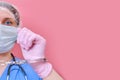 Doctor shows hands in handcuffs on pink background, copy space. Hands in medical gloves handcuffed, coronavirus quarantine,