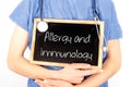 Doctor shows information on blackboard: allergy and immunology. Medical concept