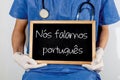 Doctor shows information on blackboard: we speak portuguese. Medical concept