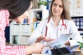Doctor shows woman on tablet result of medical examination Royalty Free Stock Photo
