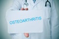 Doctor with a signboard with the text osteoarthritis