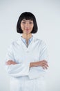 Doctor standing with arms crossed against white background Royalty Free Stock Photo