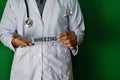 A doctor standing, Hold the Wheezing paper text on Green background. Medical and healthcare concept