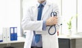 Doctor standing in office with stethoscope in hand Royalty Free Stock Photo