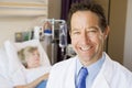 Doctor Standing In Patients Room