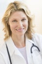 Doctor With Stethoscope Around Neck Smiling In Hospital