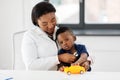 Doctor with stethoscope and baby patient at clinic Royalty Free Stock Photo