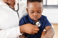 Doctor with stethoscope and baby patient at clinic Royalty Free Stock Photo