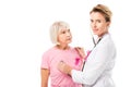 doctor with stethoscope checking health of senior woman and looking at camera