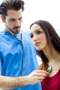 Doctor with stethoscope checking a patient