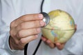 Doctor with stethoscope and globe in his hands Royalty Free Stock Photo