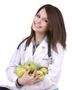 Doctor with stethoscope and group green apples.