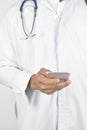 Doctor with stethoscope holding mobile phone. Royalty Free Stock Photo