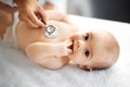 Doctor with stethoscope listening to baby patient