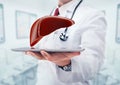 Doctor with stethoscope and liver on the tablet in the hands in hospital.