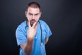 Doctor with stethoscope making look into eyes gesture