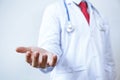 Doctor with stethoscope offering helping hands gesture Royalty Free Stock Photo