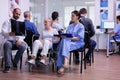 Doctor talking and pointing at radiography of disabled old woman Royalty Free Stock Photo