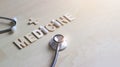 Doctor stethoscope and word wooden of medicine on wooden background, Abstract symbol, Medical and healthcare concept