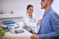 Doctor with stetoscope listens patientÃ¢â¬â¢s heart