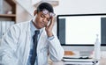 Doctor suffering from headache, stress and pain while working in a hospital. Young, tired health care professional Royalty Free Stock Photo